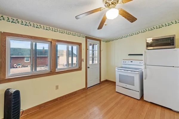 a view of an empty room with window and cabinet
