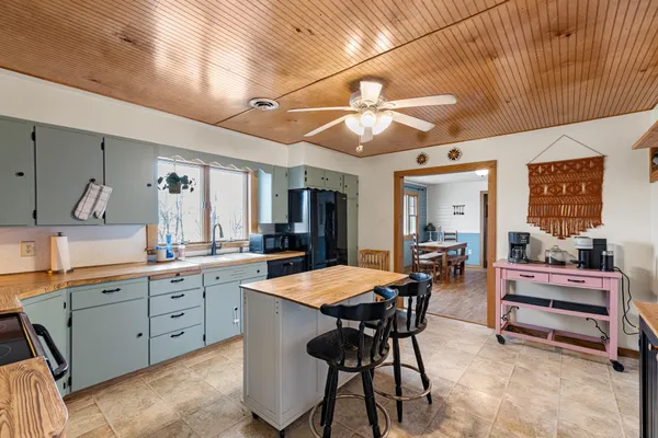 a large kitchen with a table and chairs