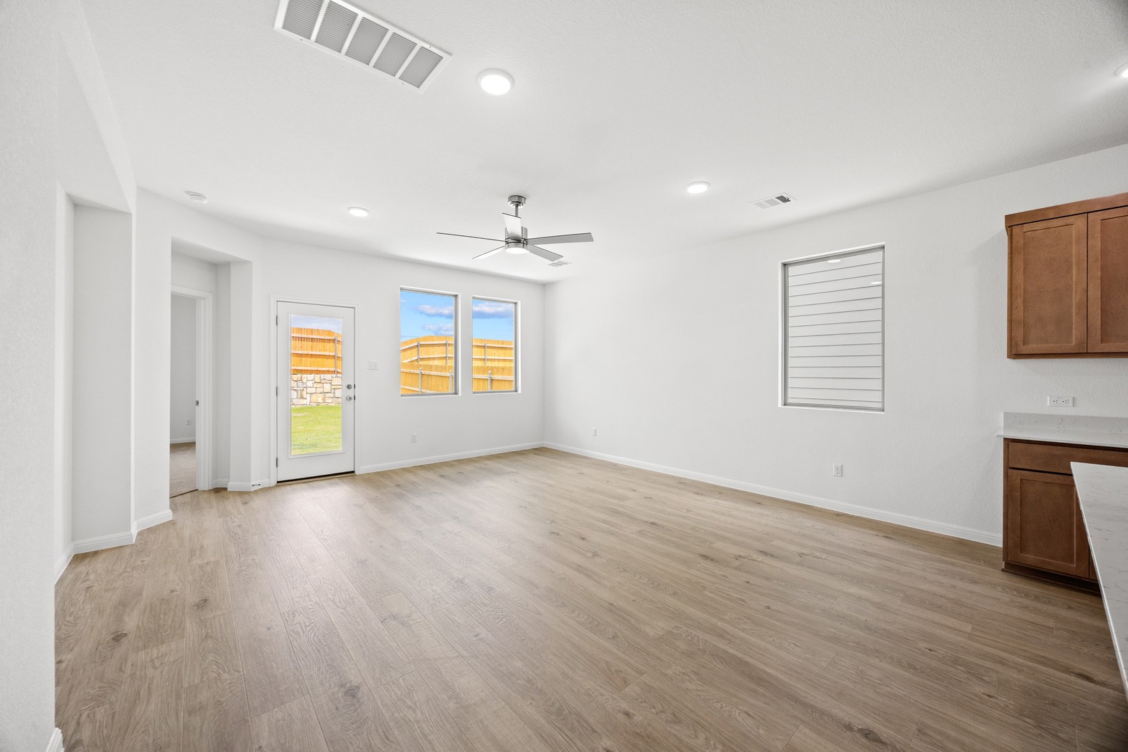 200 Hornet Street Elgin, TX 78621 - Photo 7 of 39 a view of an empty room with a window and wooden floor