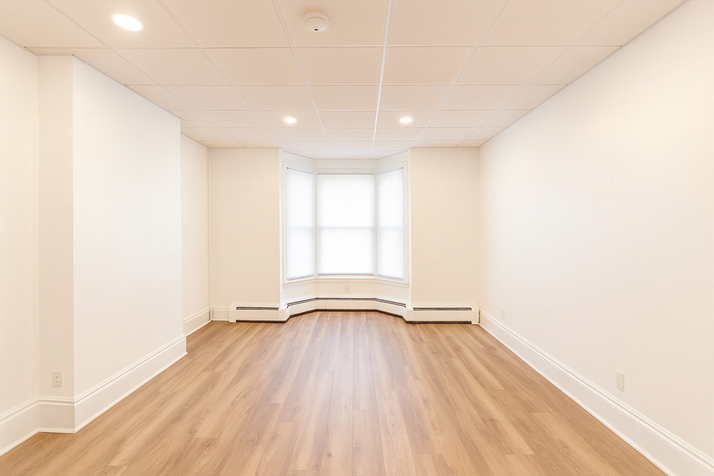 303 Princeton Street, Unit 1 Boston, MA 02128 - Photo 1 of 7 a view of empty room with wooden floor and fan