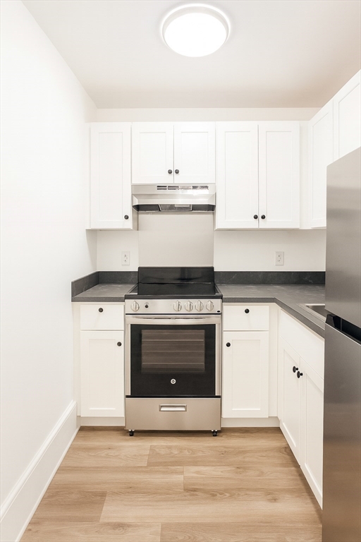 303 Princeton Street, Unit 1 Boston, MA 02128 - Photo 2 of 7 a kitchen with granite countertop a stove and a sink