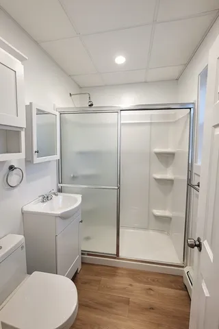 a bathroom with a sink mirror toilet and shower