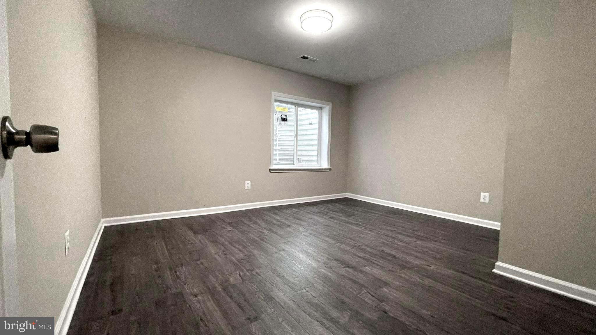 9008 Hanson Grove Court Manassas, VA 20109 - Photo 10 of 13 an empty room with wooden floor and windows