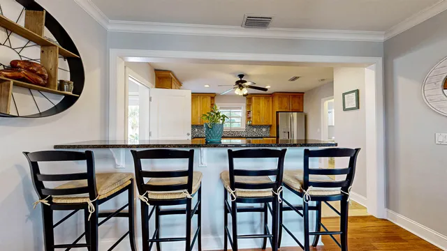 a kitchen with stainless steel appliances granite countertop a refrigerator and a stove