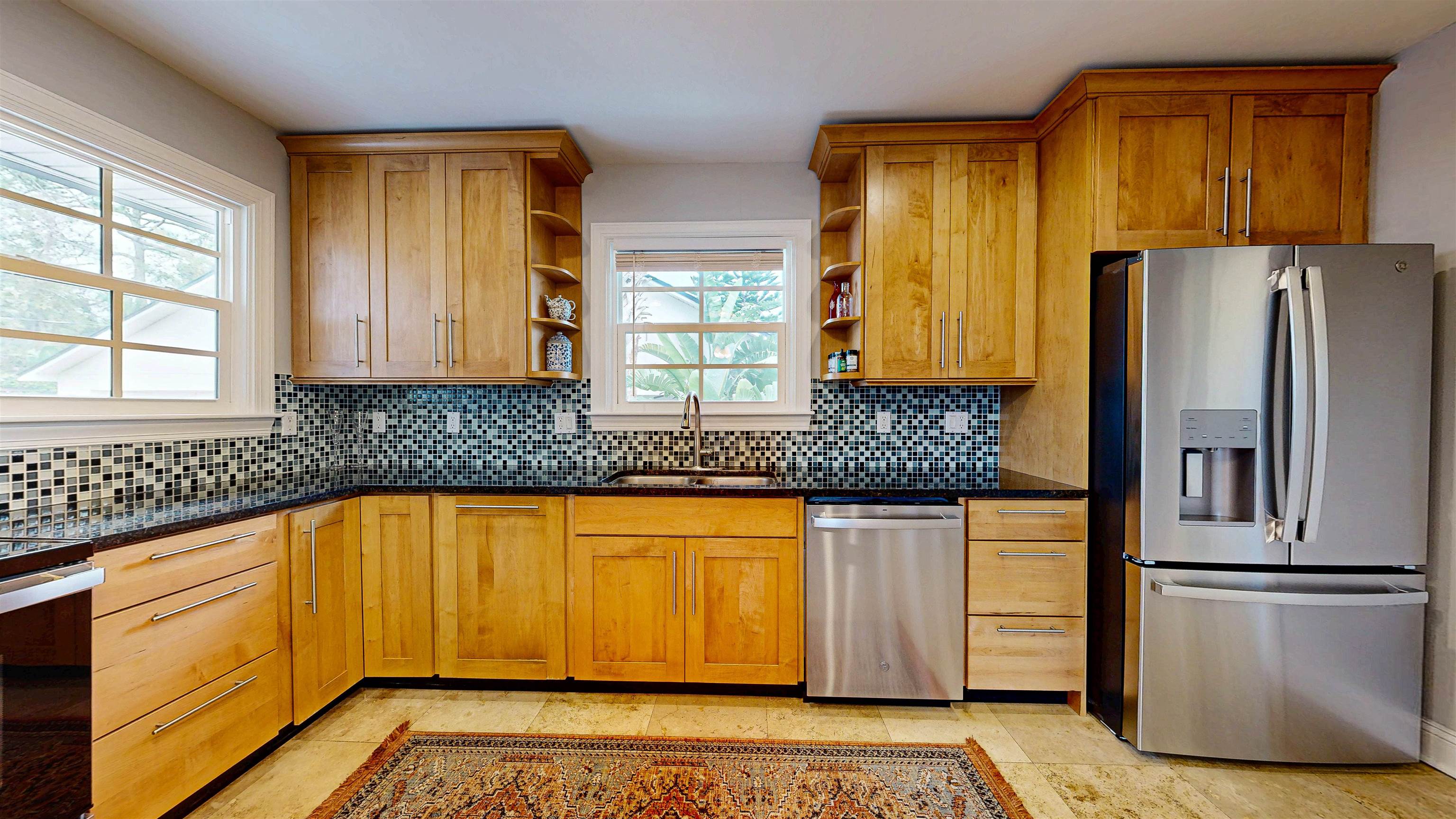 312 Minorca Avenue St. Augustine, FL 32080 - Photo 14 of 56 a kitchen with stainless steel appliances granite countertop a refrigerator and a stove