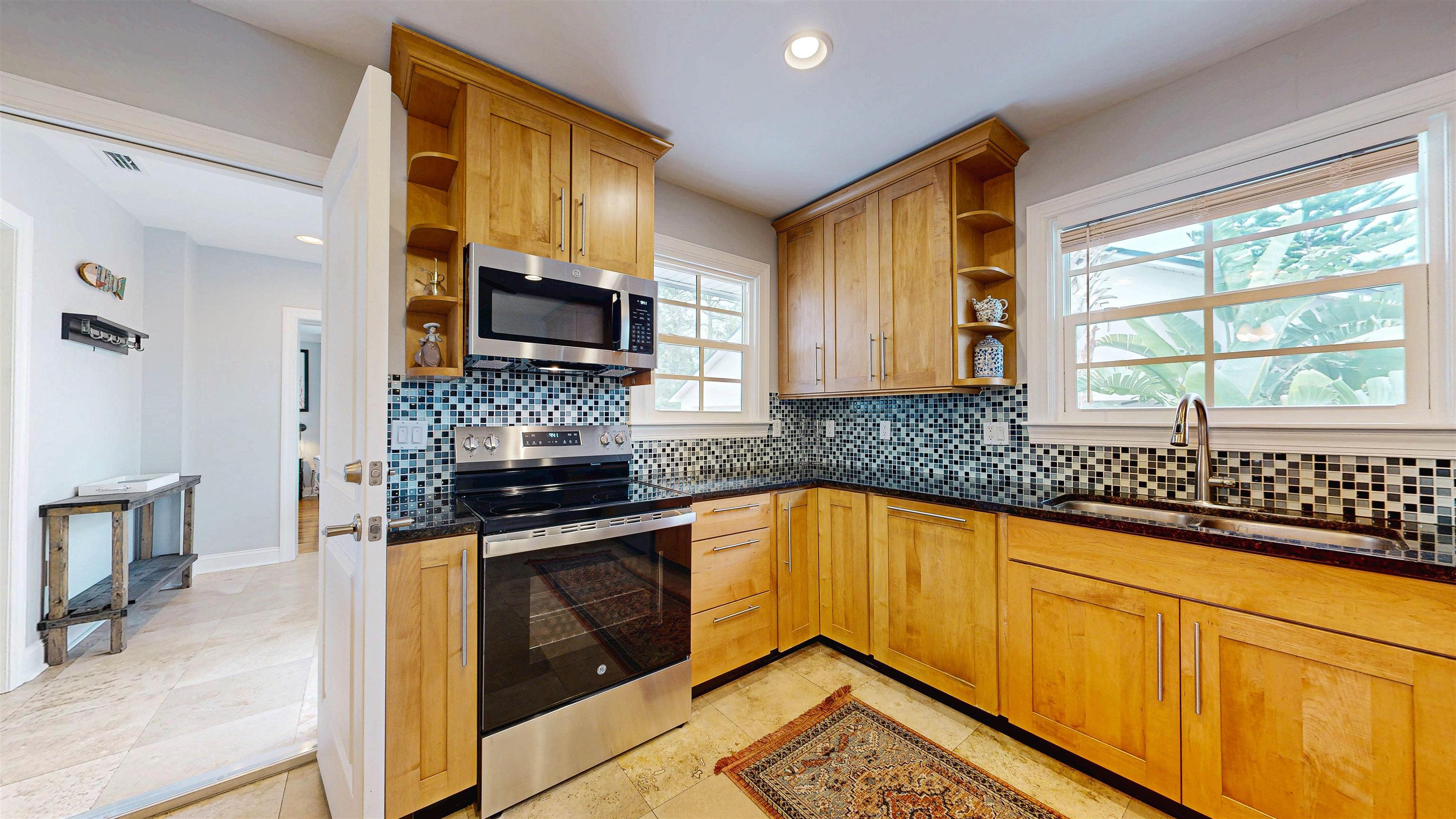 312 Minorca Avenue St. Augustine, FL 32080 - Photo 16 of 56 a kitchen with granite countertop cabinets stainless steel appliances a sink and a window