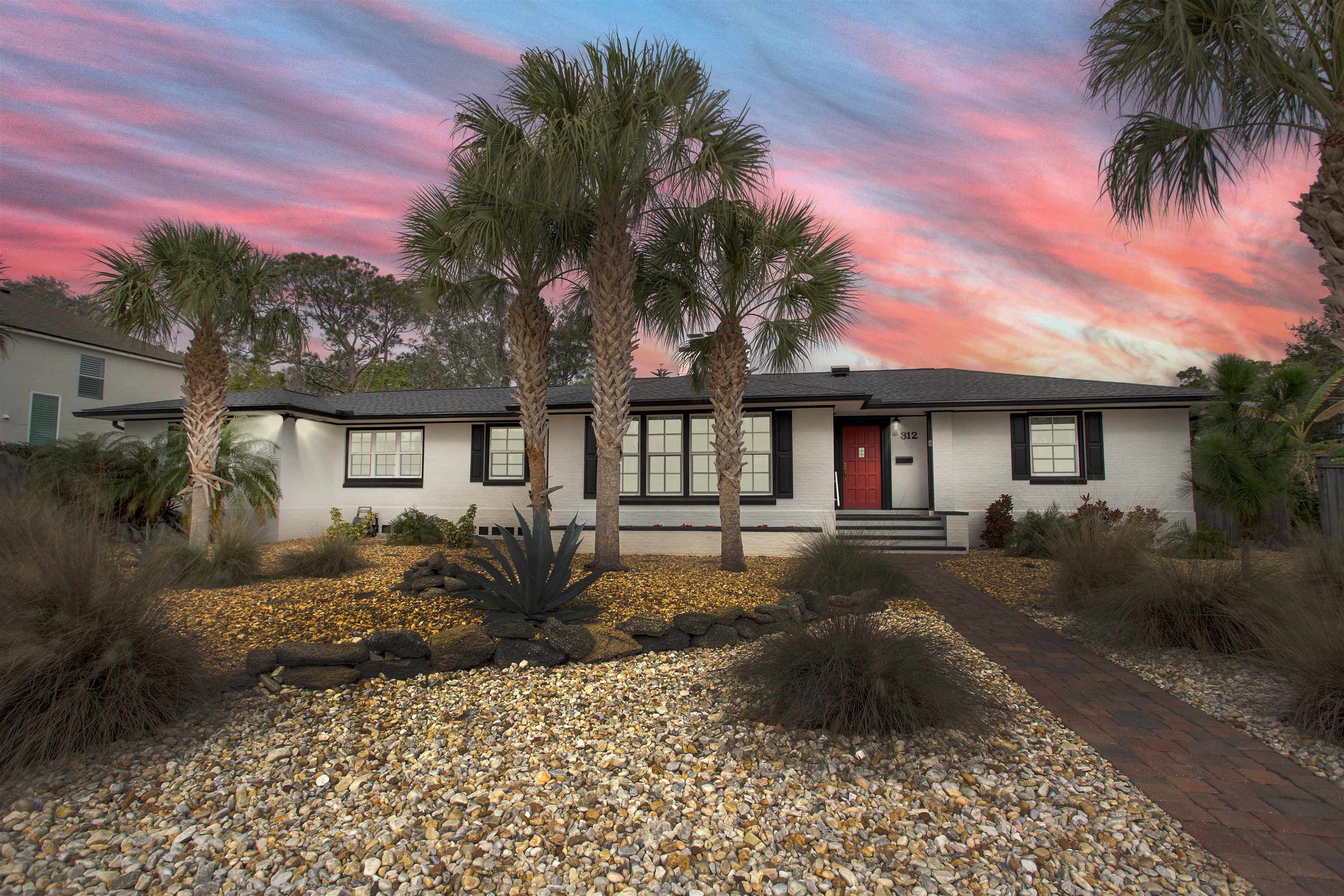 312 Minorca Avenue St. Augustine, FL 32080 - Photo 2 of 56 a front view of a house with yard and green space