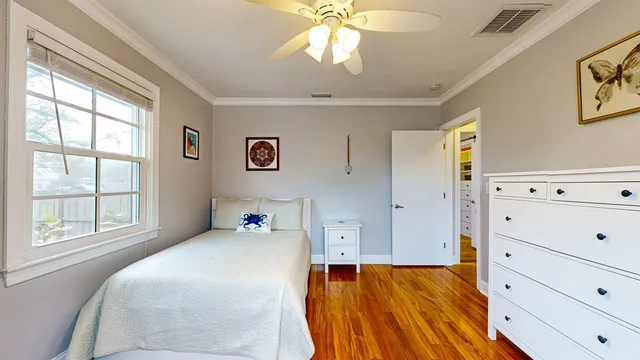 a dining room with chandelier and wooden floor