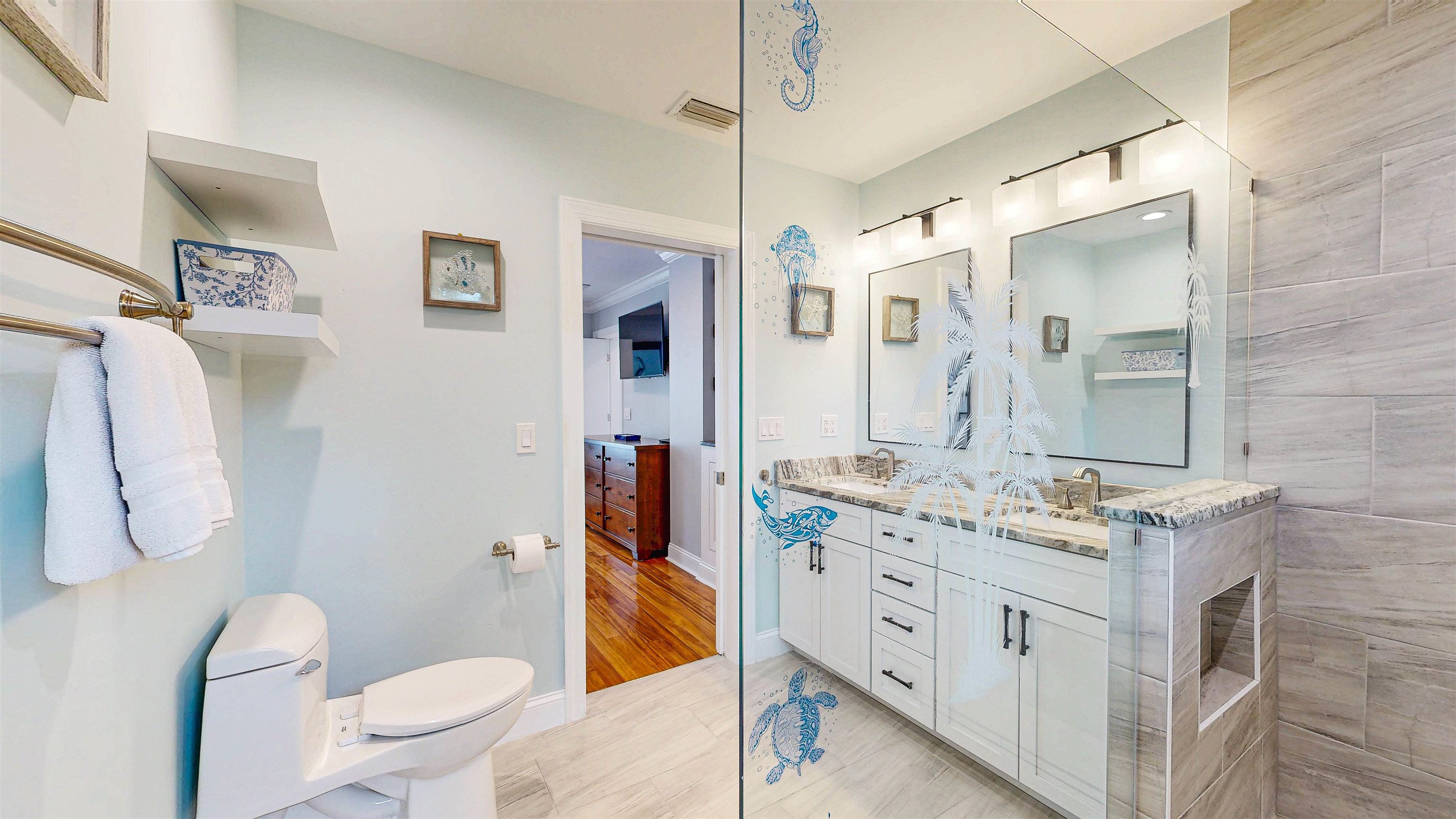 312 Minorca Avenue St. Augustine, FL 32080 - Photo 28 of 56 a spacious bathroom with a double vanity sink toilet and shower