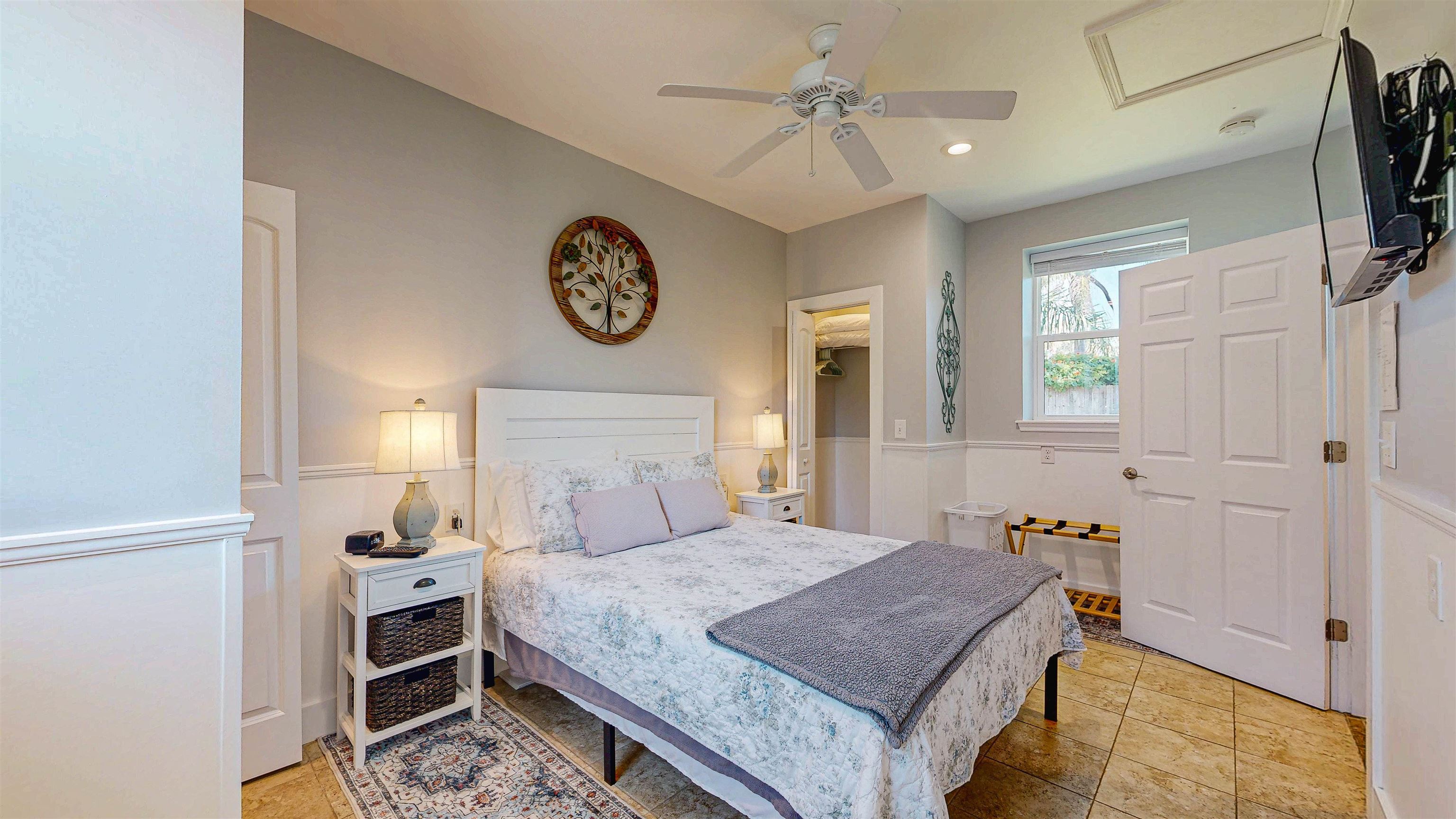 312 Minorca Avenue St. Augustine, FL 32080 - Photo 37 of 56 a bedroom with a bed and a chandelier