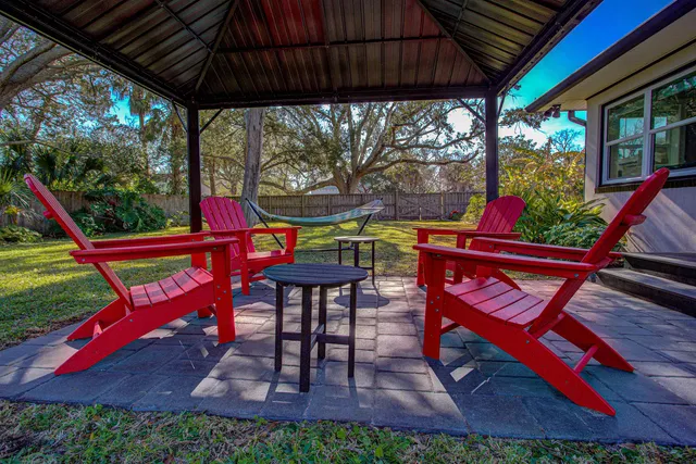 a view of a house with backyard sitting area and garden