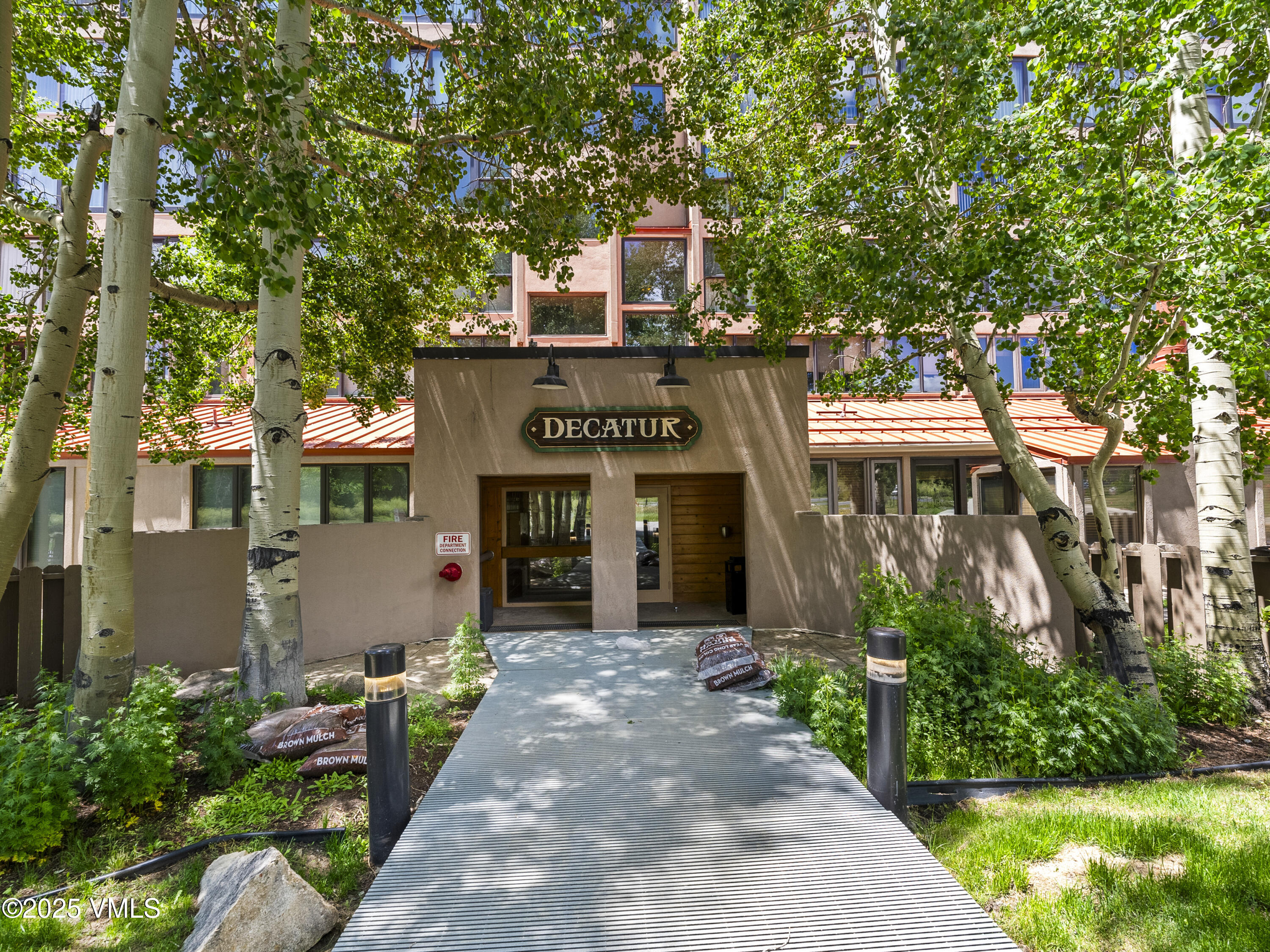 2340 Route 6, Unit 1794 Wellfleet, MA 02667 - Photo 19 of 20 a front view of a house with a yard and tree s