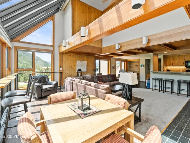 a living room with fireplace furniture and a large window
