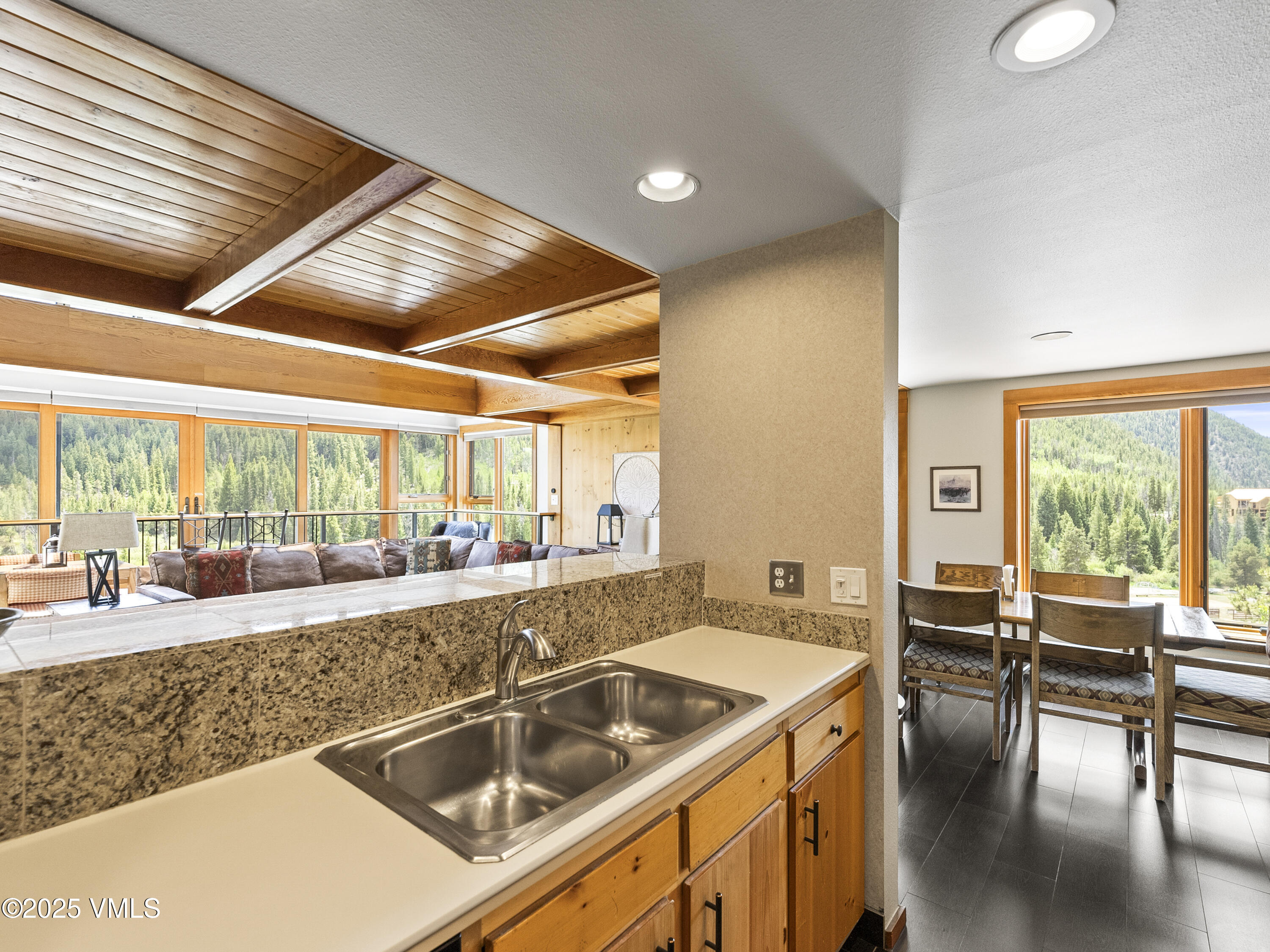 2340 Route 6, Unit 1794 Wellfleet, MA 02667 - Photo 9 of 20 a kitchen with a stove a sink and white cabinets with wooden floor