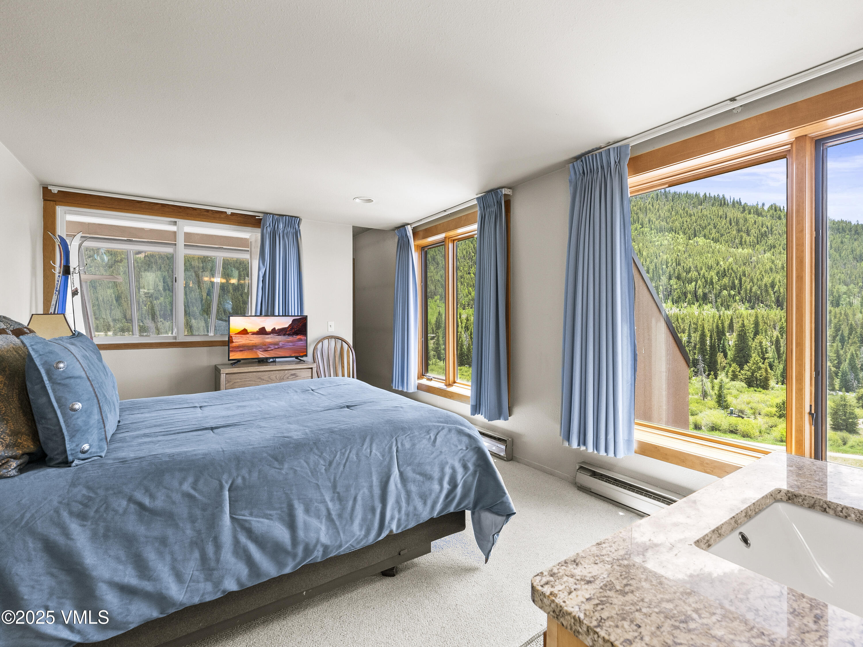 2340 Route 6, Unit 1794 Wellfleet, MA 02667 - Photo 10 of 20 a bedroom with a bed and glass windows