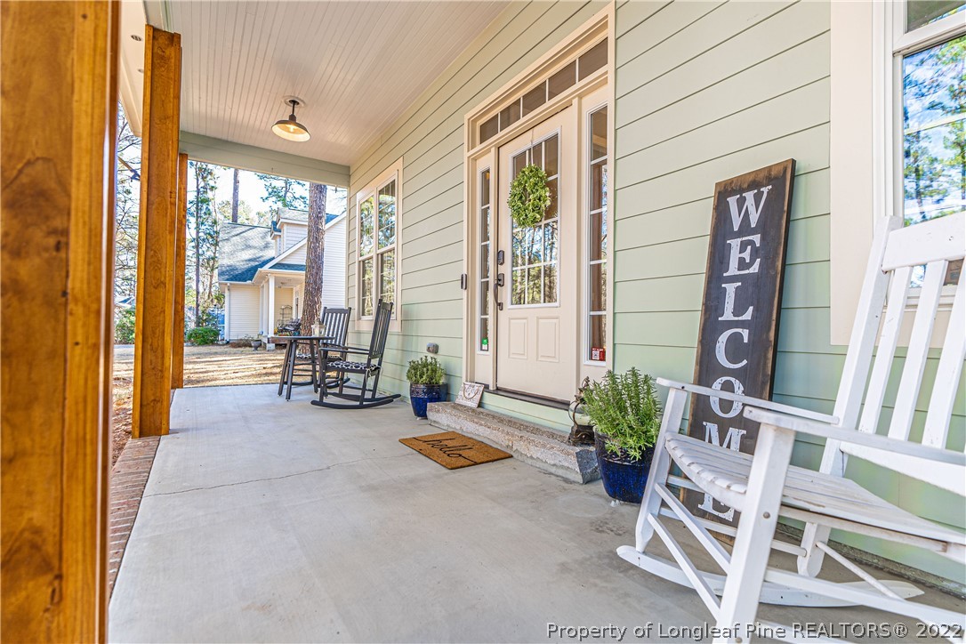 1163 Rays Bridge Road Whispering Pines, NC 28327 - Photo 3 of 37 a view of an outdoor space with porch and furniture