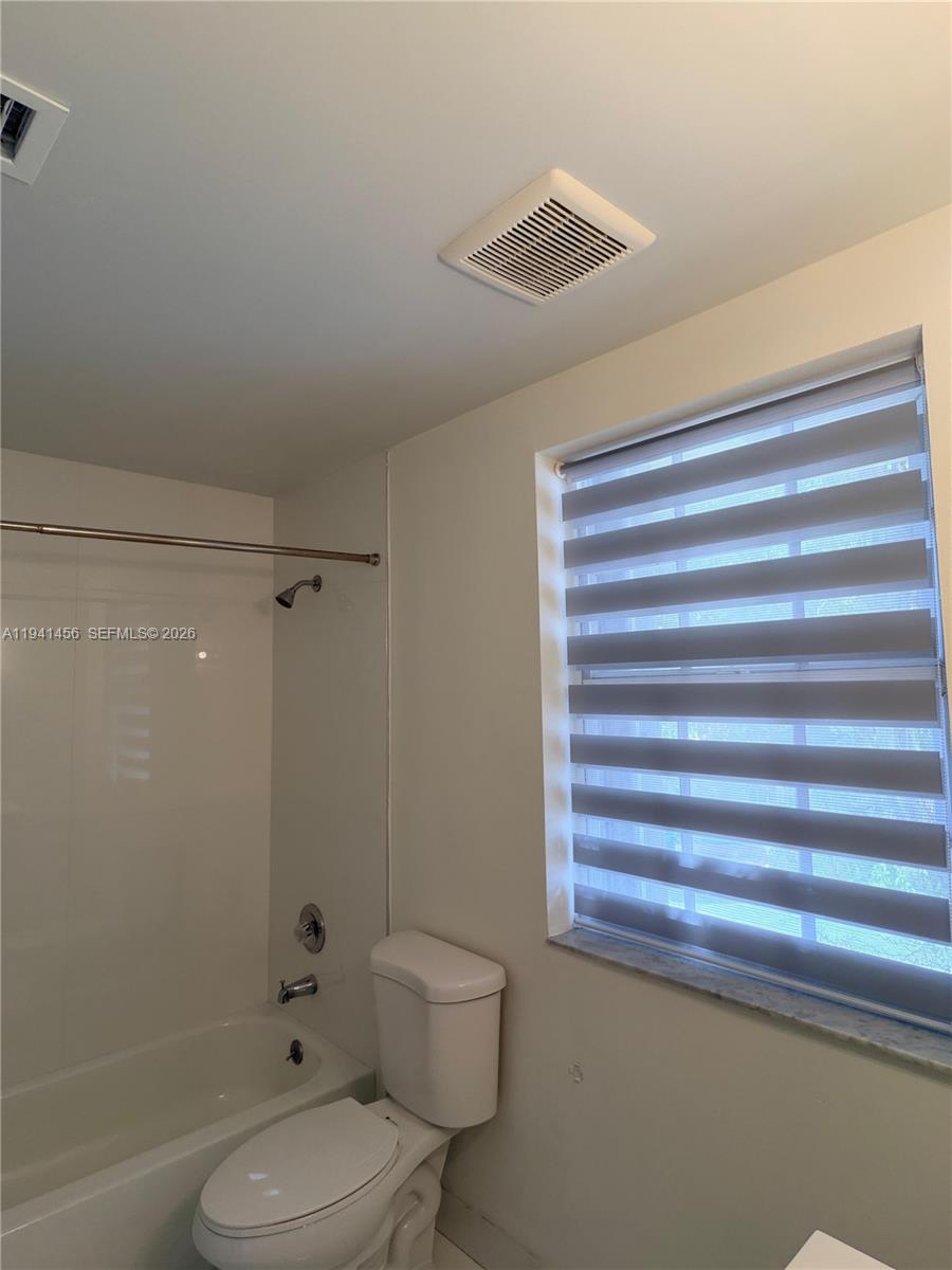 6514 Southwest 128th Place, Unit 6514 Miami, FL 33183 - Photo 14 of 18 a bathroom with a toilet and a shower