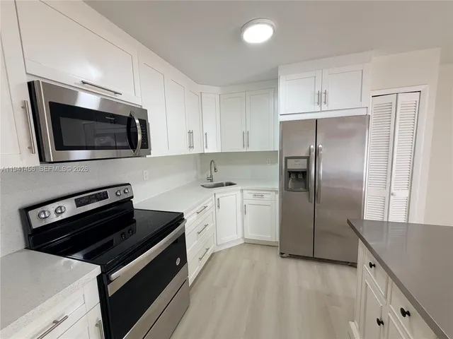 a kitchen with a refrigerator stove and microwave