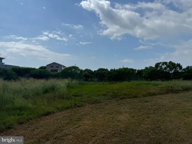 a view of a lake and green valley
