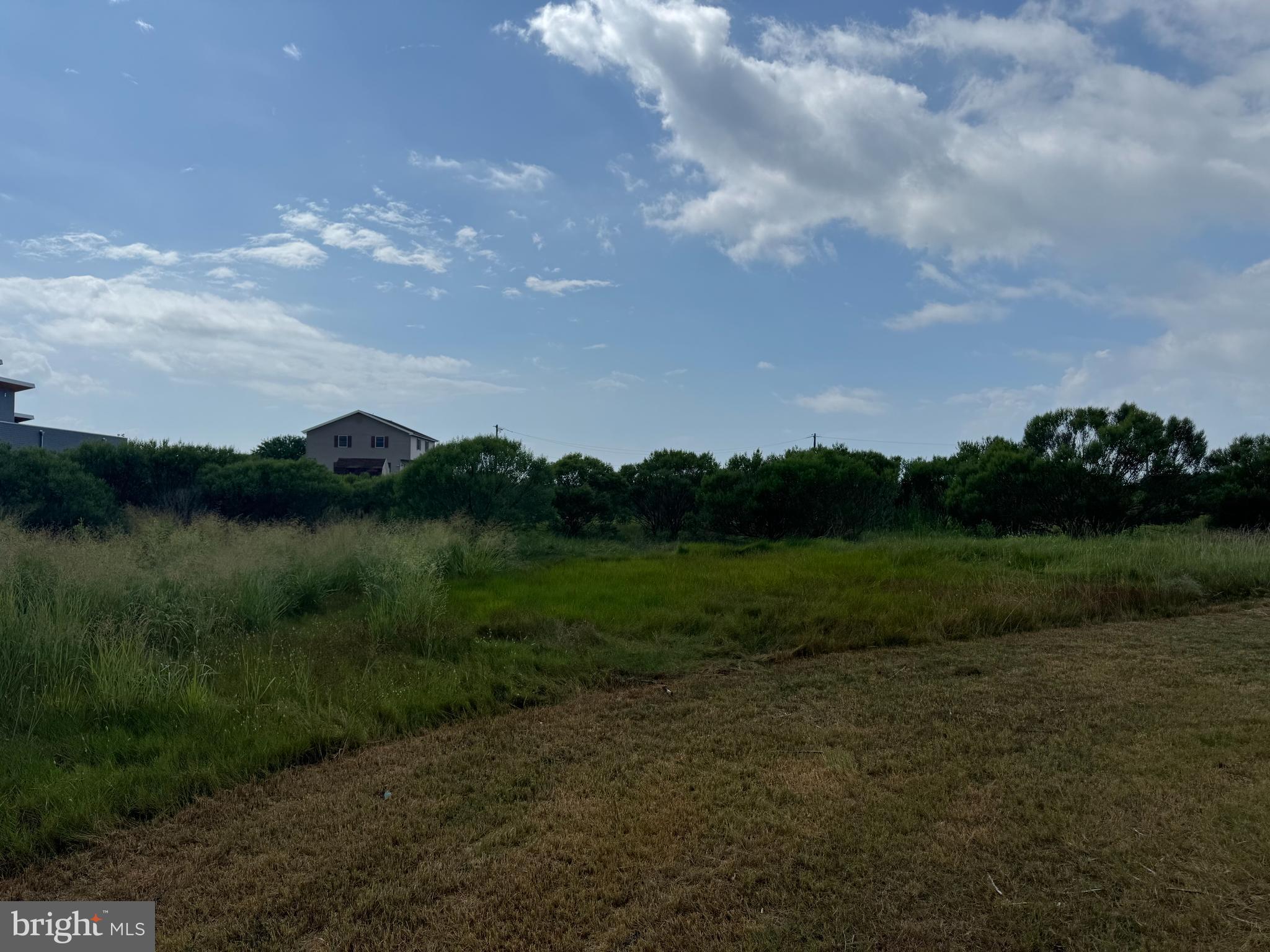 a view of a lake and green valley