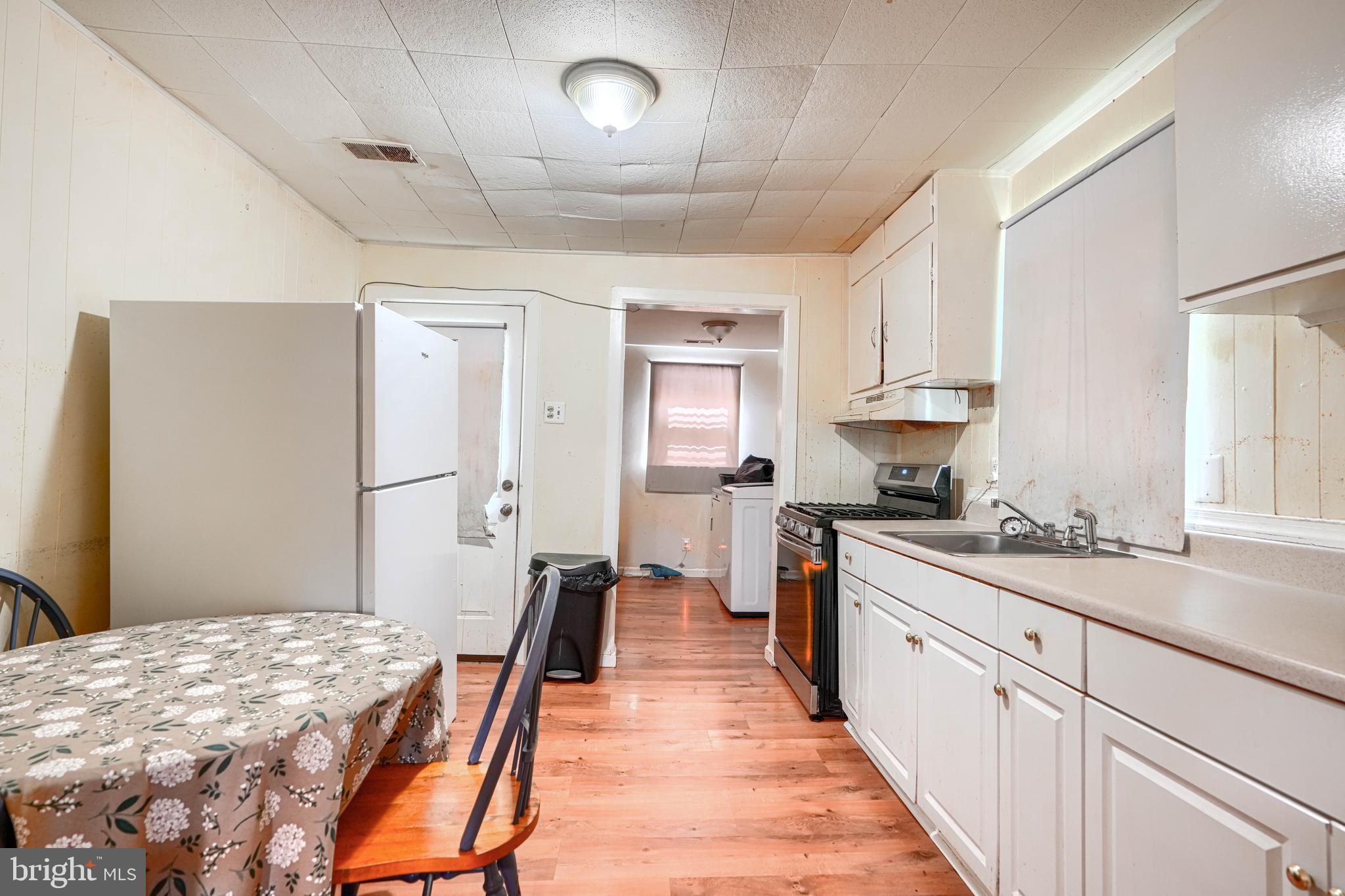 502 Grovethorn Road Middle River, MD 21220 - Photo 7 of 20 a large white kitchen with sink and cabinets