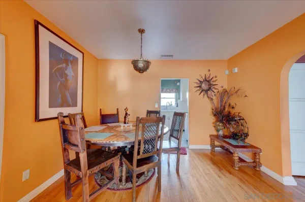 a view of a dining room with furniture and wooden floor