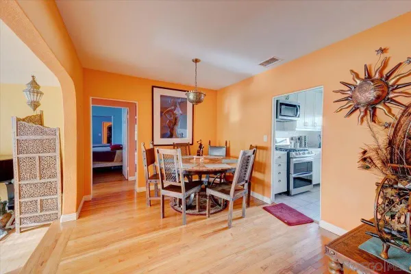 a dining room with furniture and wooden floor