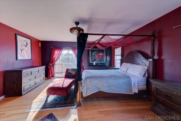 a bedroom with a bed a window and dresser