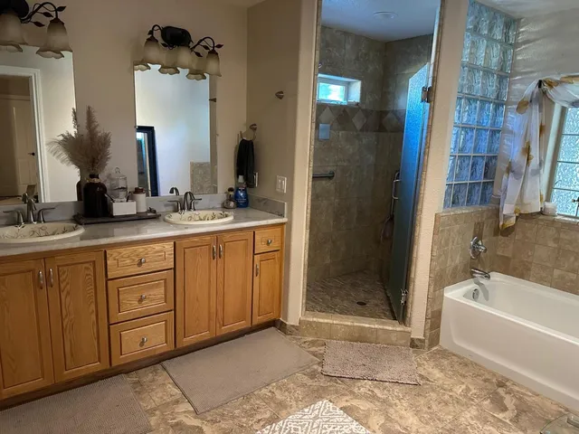 a bathroom with a double vanity sink and a mirror