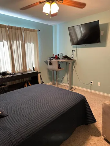 a bedroom with a bed and flat screen tv