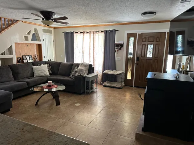 a view of a livingroom with wooden floor and a sink