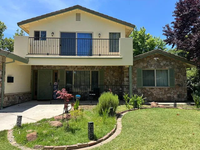 a front view of a house with a yard and porch