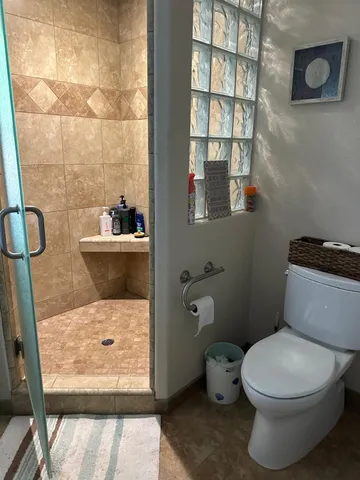 a bathroom with a toilet and a shower