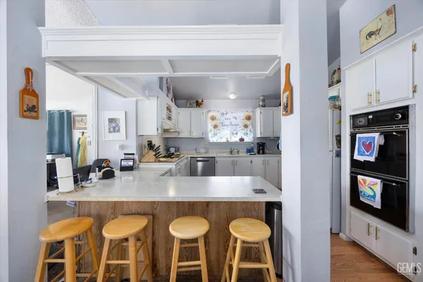 a kitchen with stainless steel appliances granite countertop a sink and cabinets