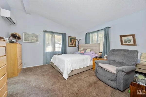 a spacious bedroom with a bed and a couch