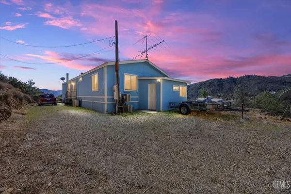 a view of a house with a yard and tree s