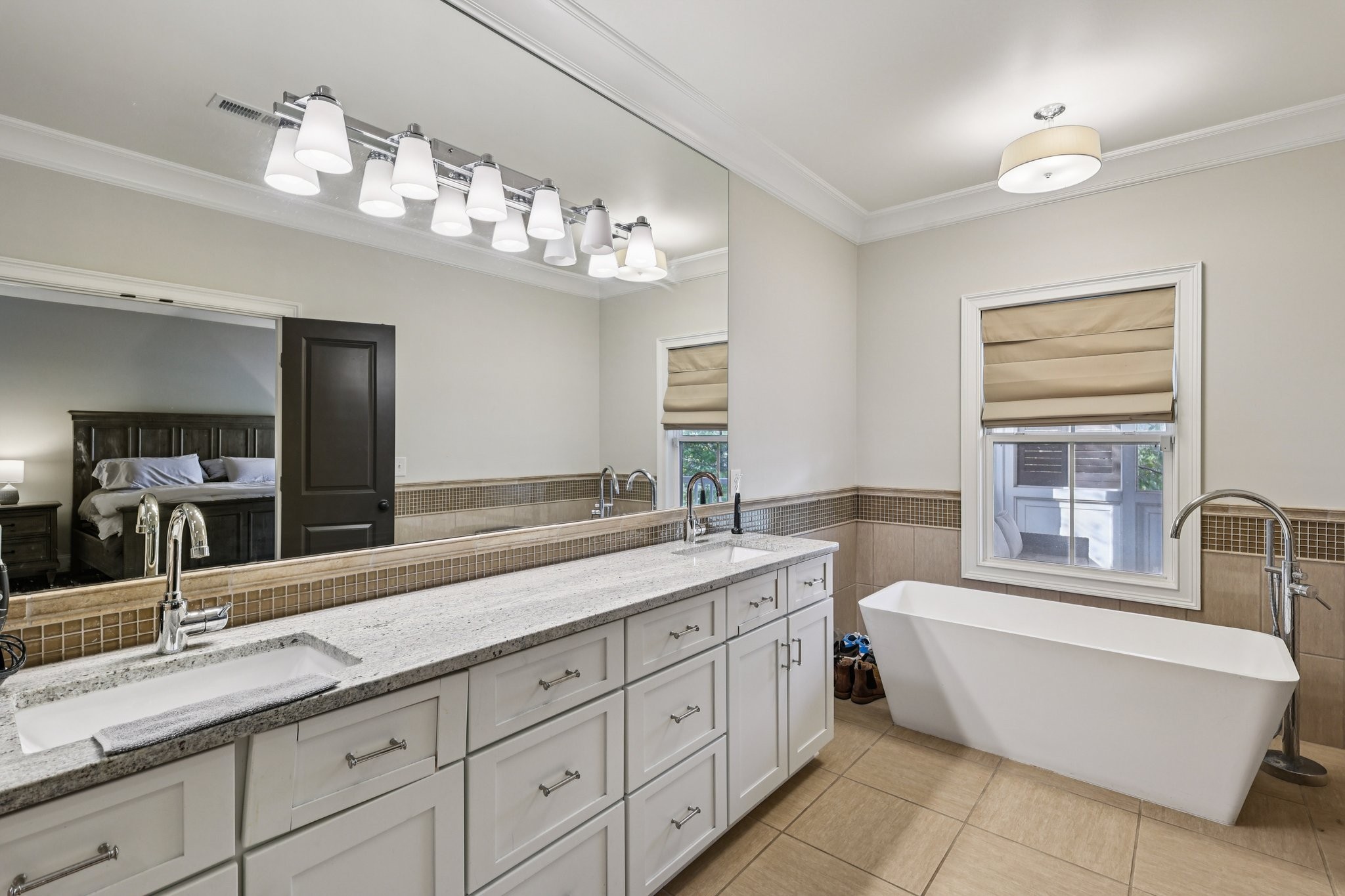 4129 River Links Drive Spring Hill, TN 37174 - Photo 16 of 33 a spacious bathroom with a double vanity sink large mirror and a bathtub