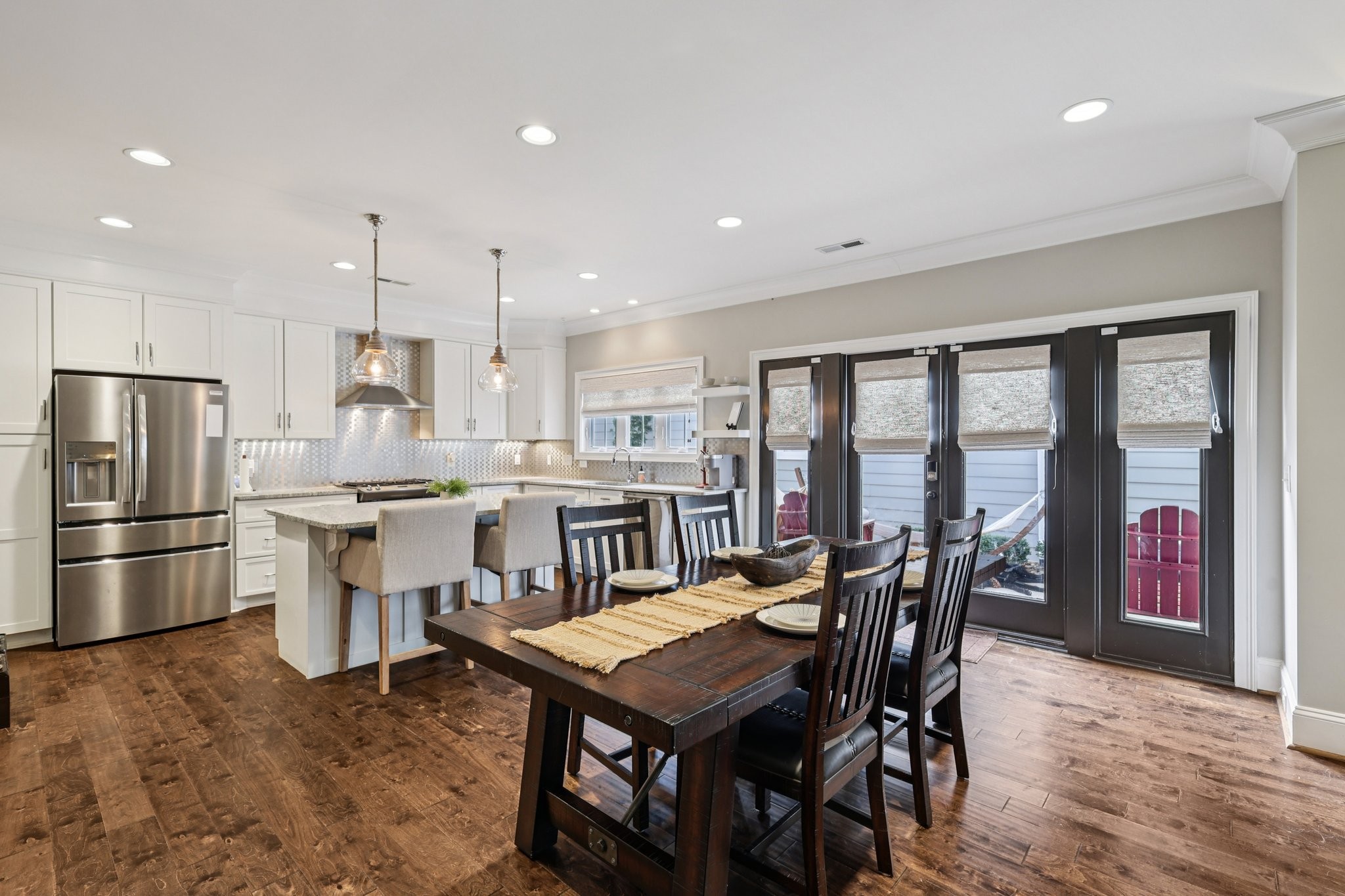 4129 River Links Drive Spring Hill, TN 37174 - Photo 6 of 33 a kitchen with a dining table chairs and refrigerator