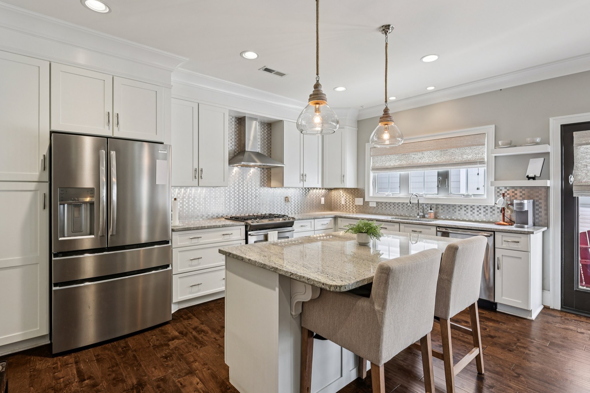 4129 River Links Drive Spring Hill, TN 37174 - Photo 9 of 33 a kitchen with stainless steel appliances a refrigerator a stove a sink a dining table and chairs