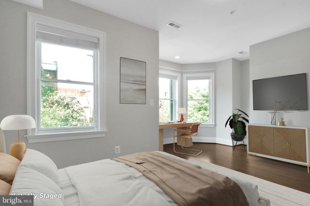 a bedroom with a large bed and a large window