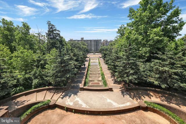 a view of a house with a big yard and large trees
