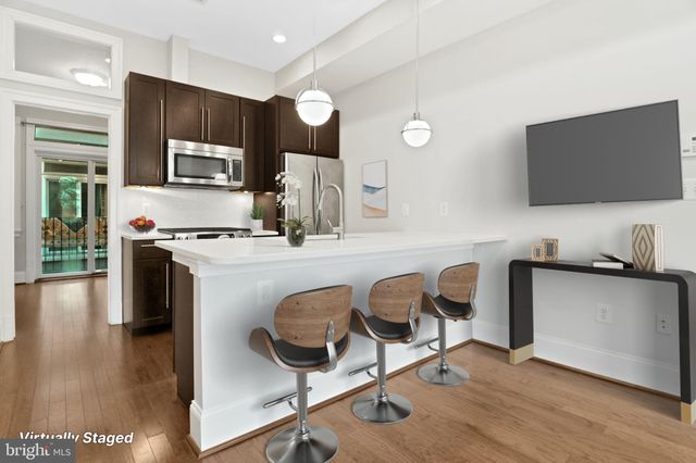 a work place with granite countertop furniture and wooden floor