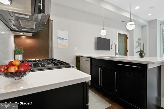 a kitchen with a sink a stove and cabinets