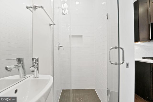 a bathroom with a tub sink and shower