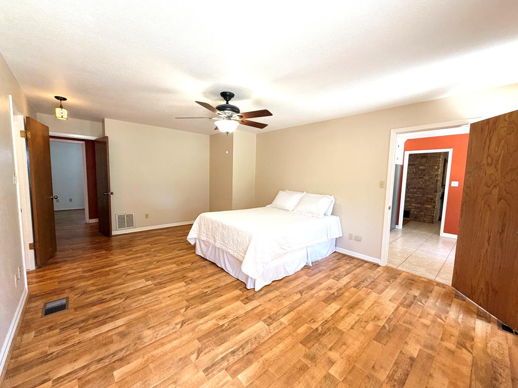 707 Rimrock Road Kerrville, TX 78028 - Photo 29 of 55 a bedroom with a bed and a walk in closet