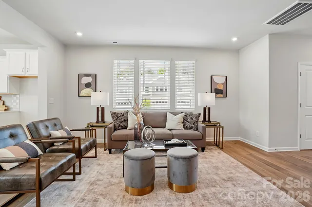 a living room with furniture a rug and a large window