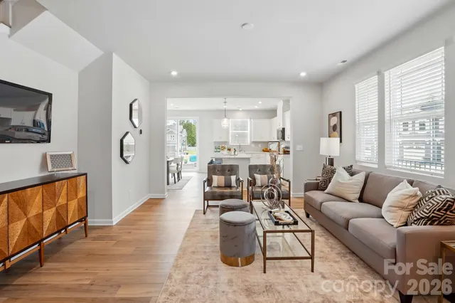 a living room with furniture wooden floor and a flat screen tv