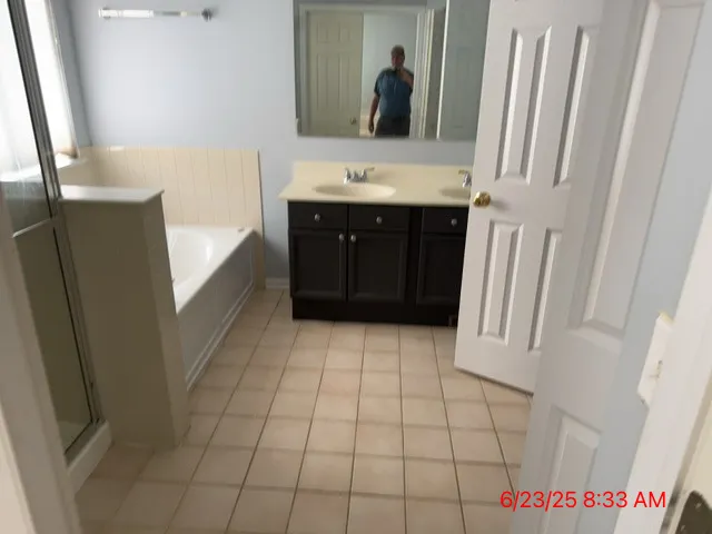 a bathroom with a sink a mirror and a bathtub