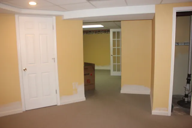 an empty room that has a grey walls