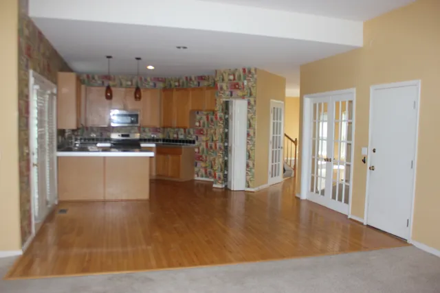 a large kitchen with stainless steel appliances granite countertop a stove and a refrigerator